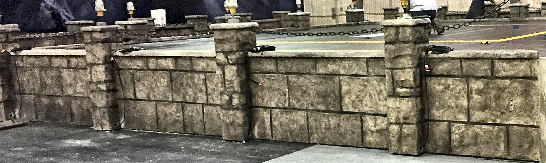 Wide carved stone wall built like a film set